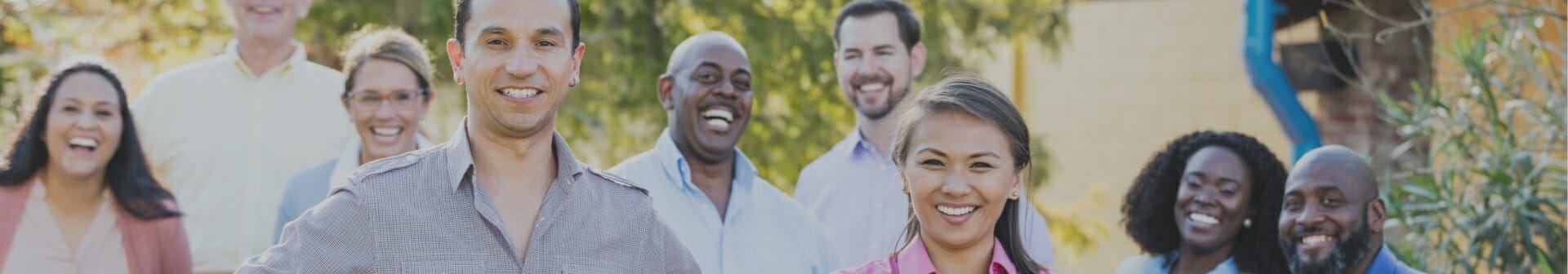 9 coworkers smiling for a group photo